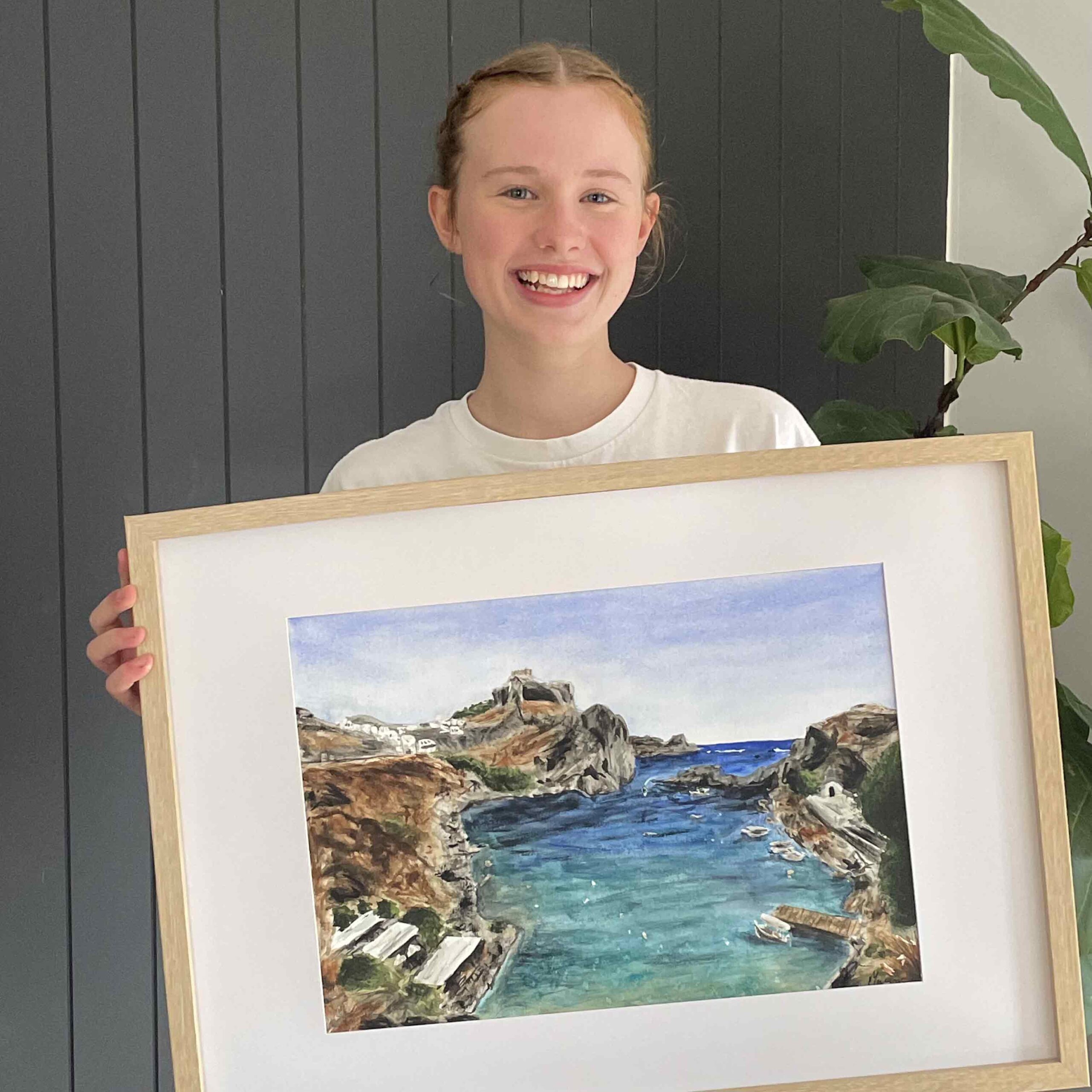 mylie weir holding a watercolour commissioned artwork of a holiday destination in athens